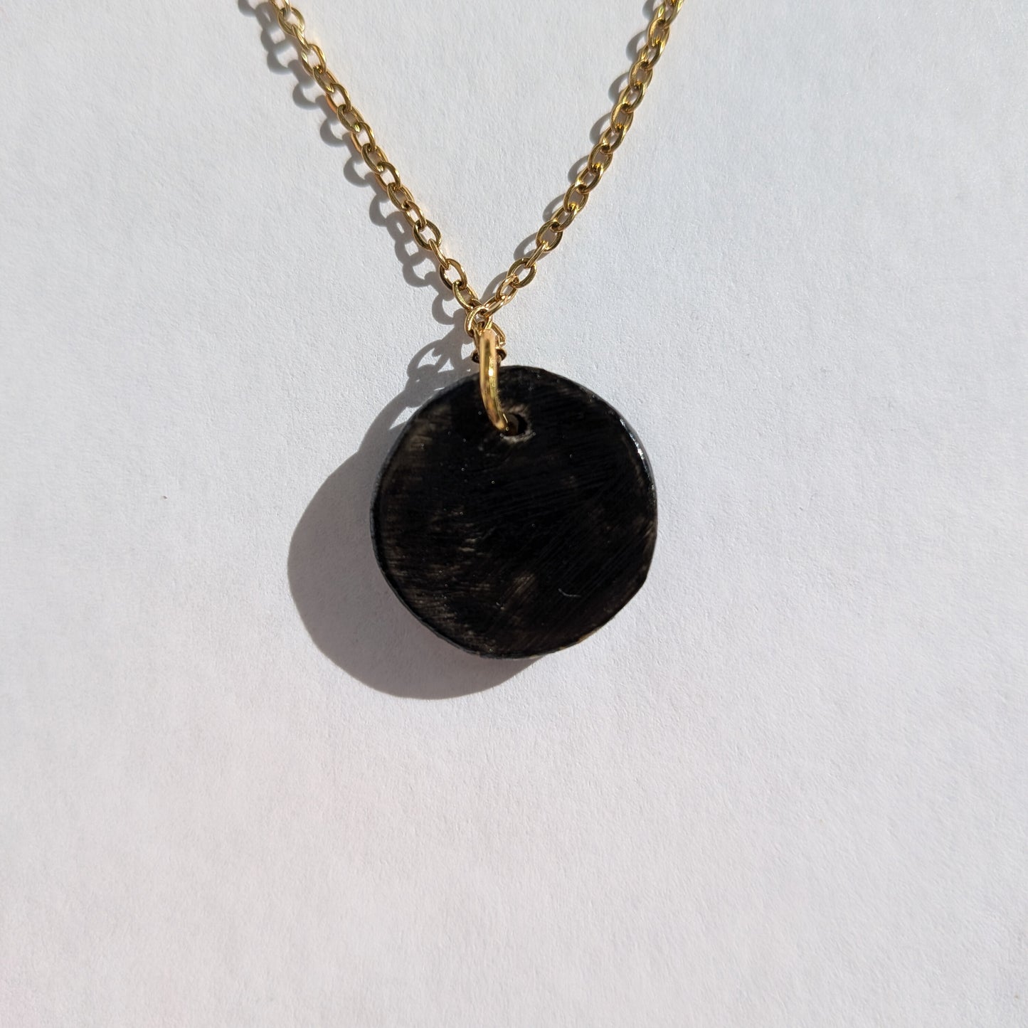 Le chat blanc au ruban vert et pendentif rouge